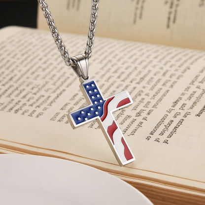 Pictured from the left is a stainless steel American flag cross pendant with a bible in the background