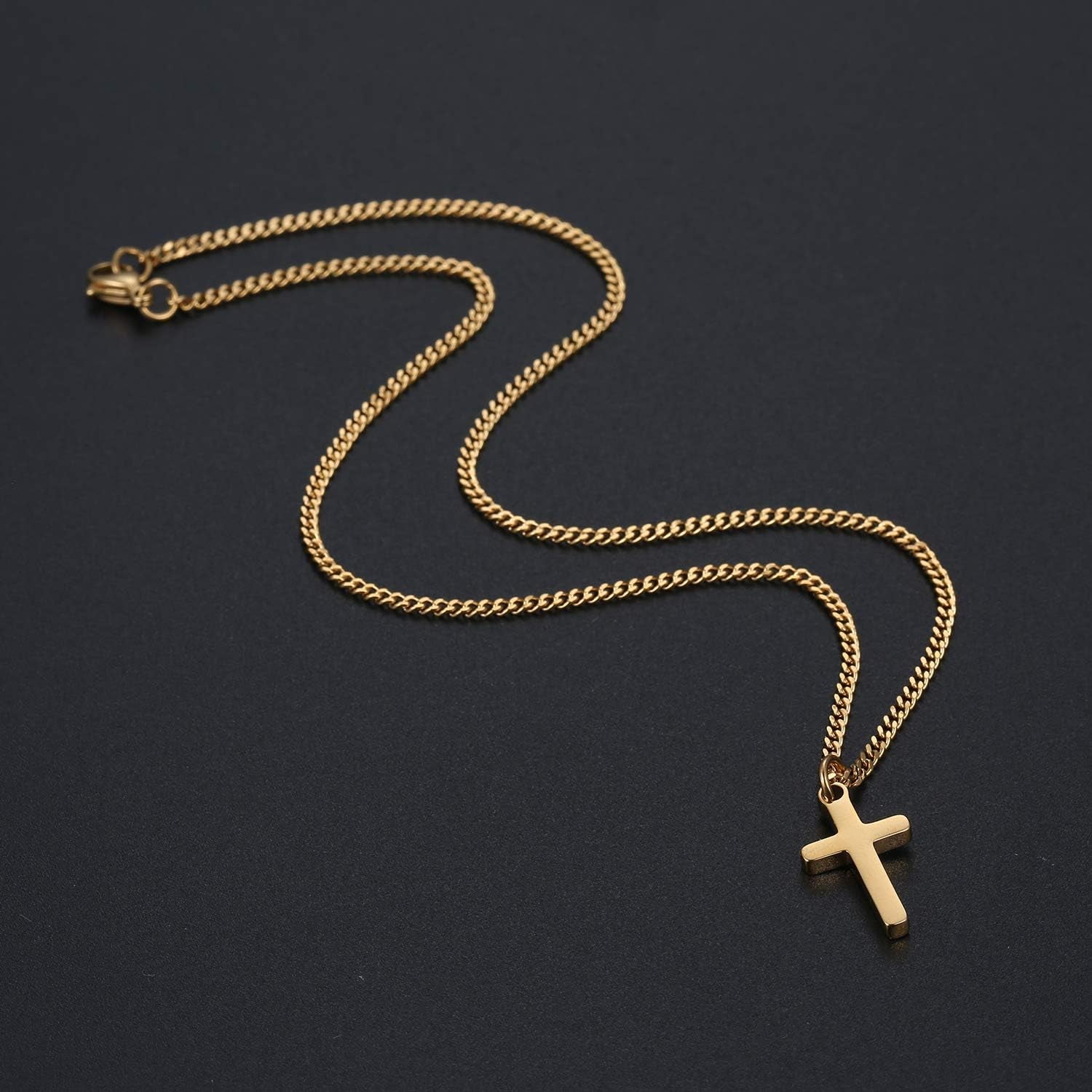 a picture of gold cross necklace on a black background