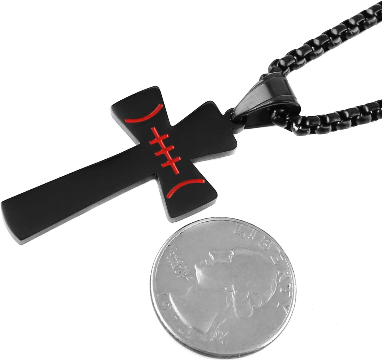 close up picture from the right of black cross football pendant jewelry necklace for men with a box chain next to a quarter for size depth