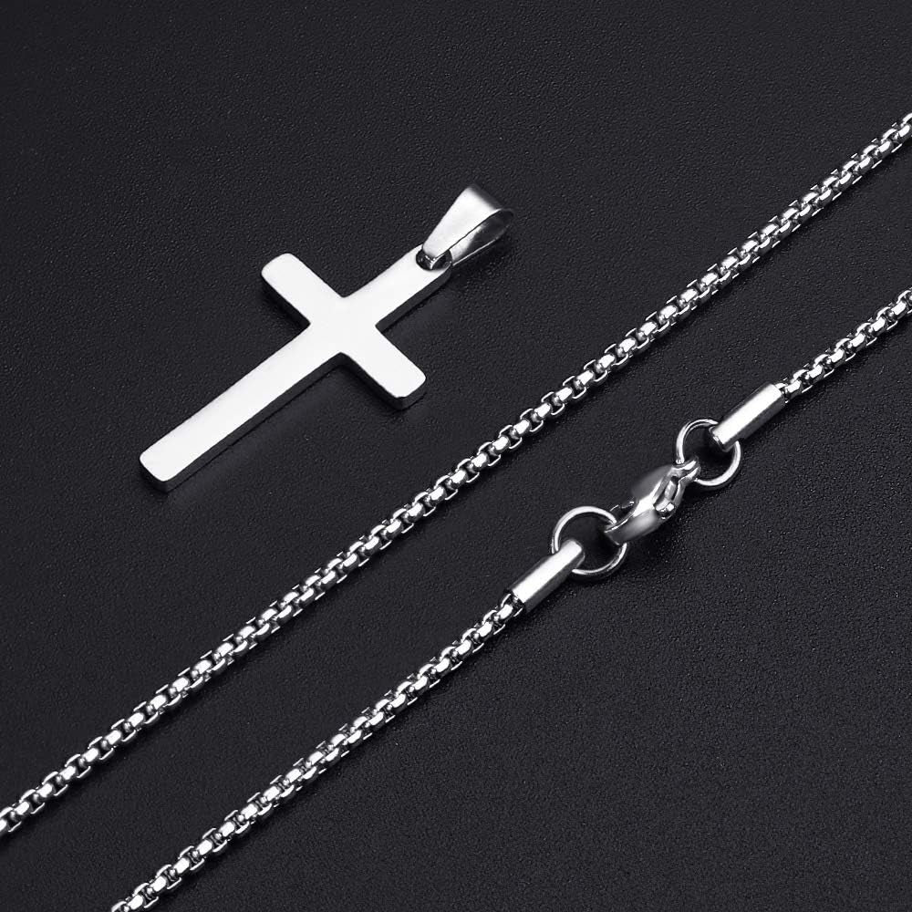 picture from the right of a men's stainless steel cross pendant jewelry. the pendant is separated from the chain necklace and the clasp on the right to show sizing